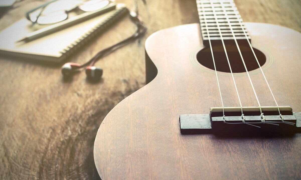Wooden ukulele on a table representing a beginner’s guide to learning the ukulele