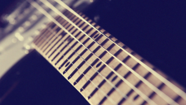 Close-up of electric guitar strings and fretboard