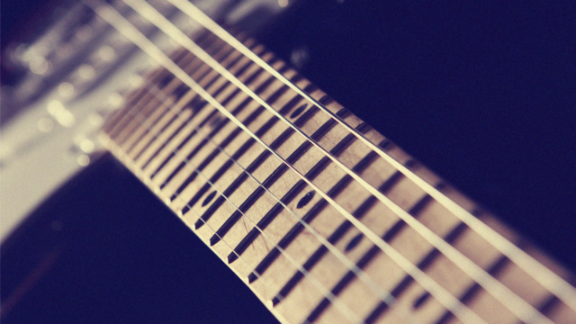 Close-up of electric guitar strings and fretboard