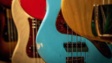 Active and passive bass guitars side by side showing pickups, controls, and electronics differences