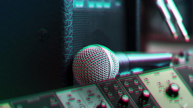 Close-up of a dynamic microphone, guitar amplifier, and synthesizer during a synth recording session for the blog “Recording Synths Through Guitar Amps: 5 Tips”