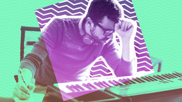 Aspiring musician writing music at keyboard with headphones around his neck, representing songwriting process