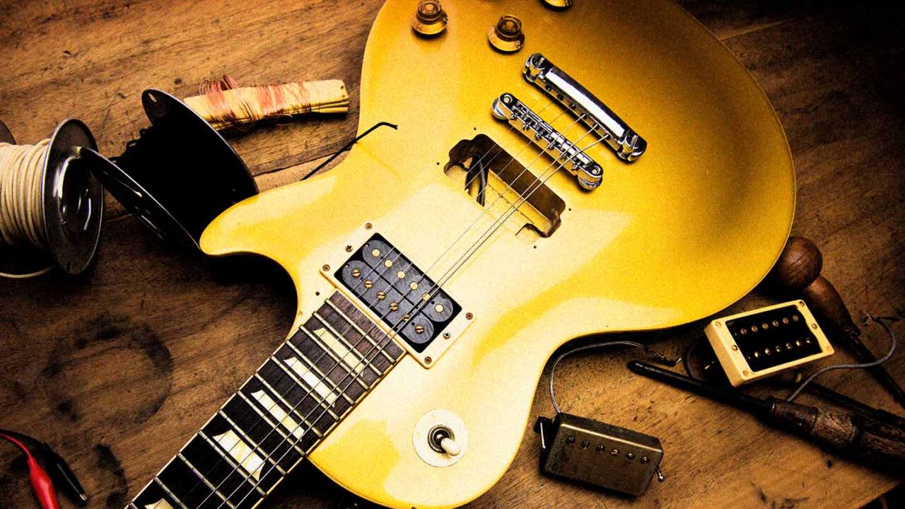 Electric guitar with exposed pickup cavity and replacement humbucker pickups during an electric guitar pickup installation.