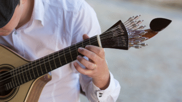 Close-up of a fado guitar being played, featured in the blog “Traditional Musical Instruments from Around the World”