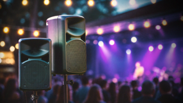 Two professional PA speakers at a live event illustrating a beginner’s guide to choosing a first PA system, including full-range and live sound setups.