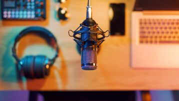 Essential Recording Techniques for Music Producers: Studio microphone and headphones set up for recording music in a home studio.